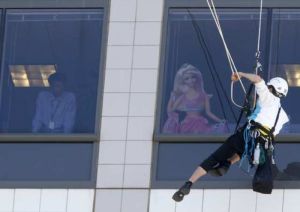Signs hung on Mattel  building in El Segundo by Greenpeace protesting Barbie and Ken